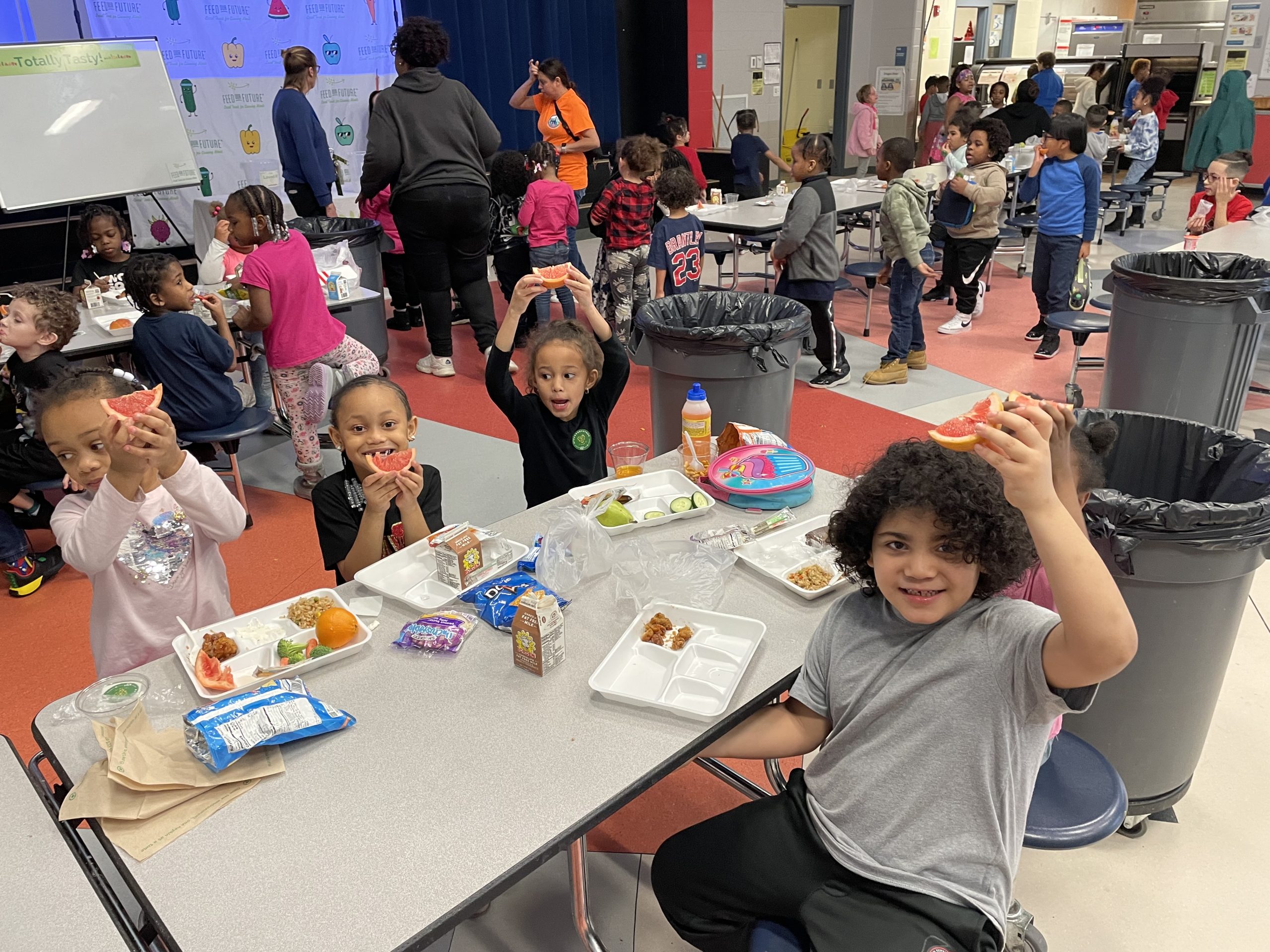Young students enjoying fresh fruit