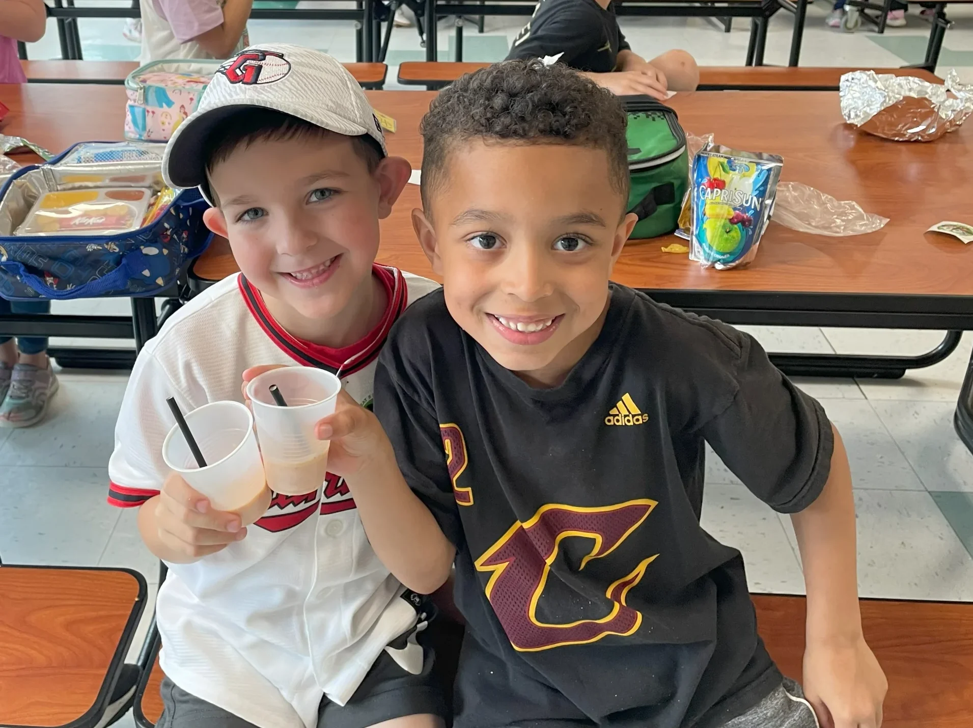 Two boys enjoying locally produced healthy drinks